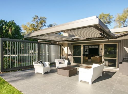 Outdoor heaters hanging on louver structure over outdoor sitting area