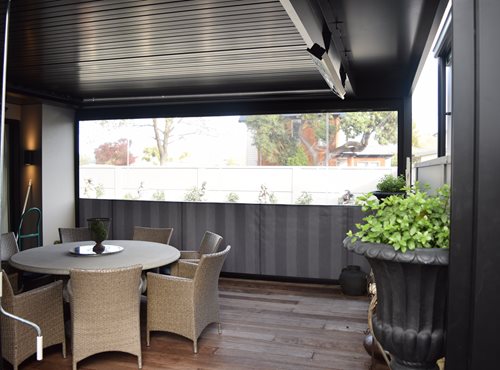 Outdoor heaters hanging on louver structure on outdoor porch and dining area